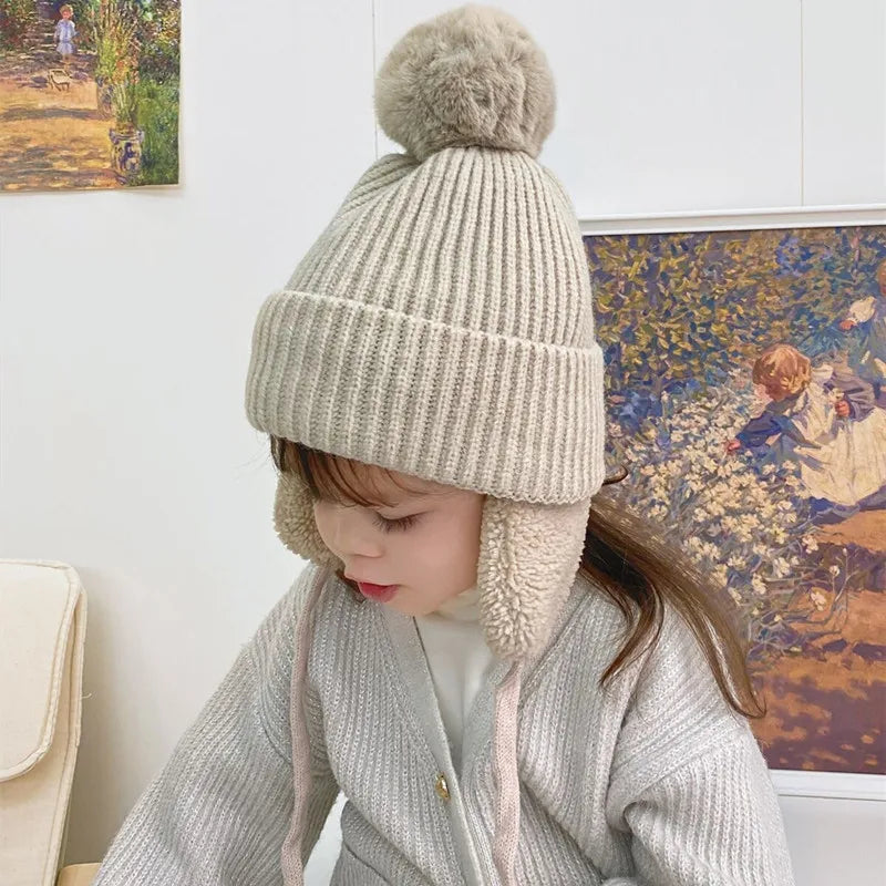 Bonnet tricoté pour enfants avec protège-oreilles et pompon, doublure douce en polaire, bonnet d'hiver chaud pour garçons et filles | Sansoti