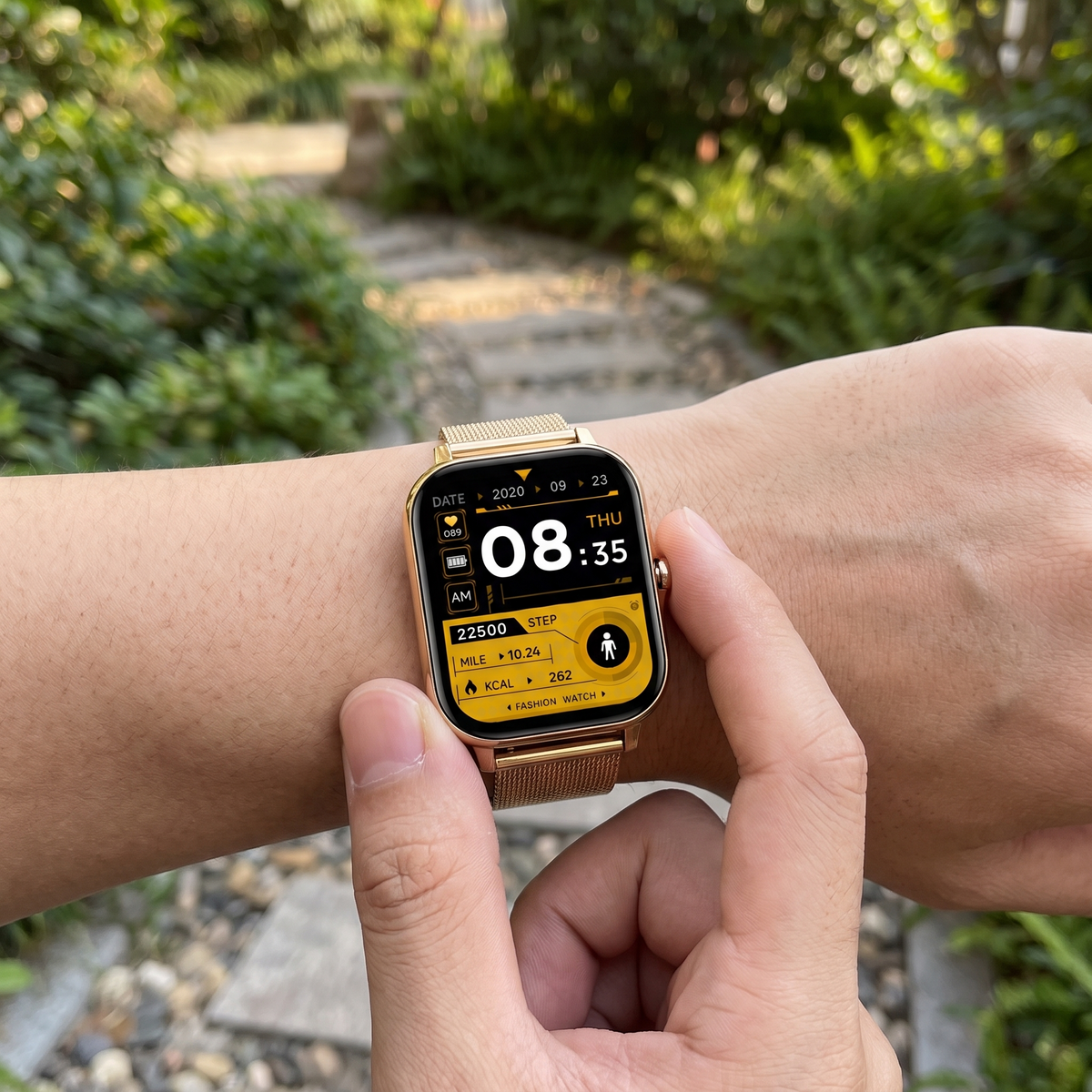 Alarmhorloge met SOS knop om de pols op een tuinpad
